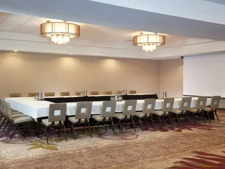 meeting space with tables and chairs in u shape setting at doubletree spectrum
