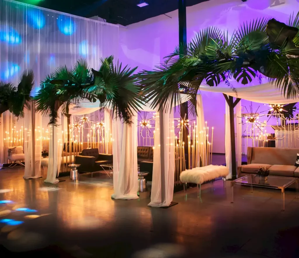 event set up with white tents lighting and green palm trees at av irvine
