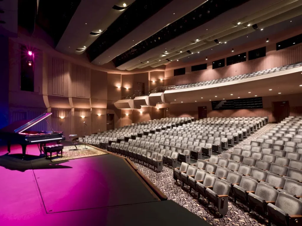 An empty showroom with a piano on the stage