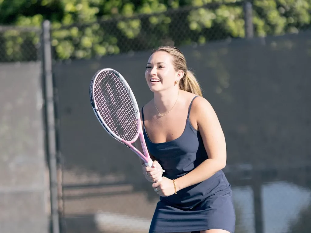 A woman plays tennis at irvine courts