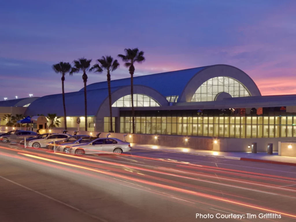 exterior of john wayne airport with cars parked night time