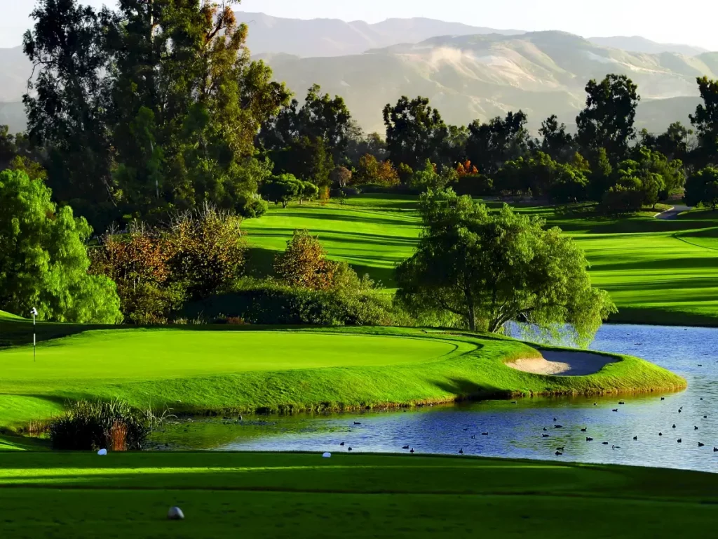 open fairways pond hills and trees at oak creek golf course