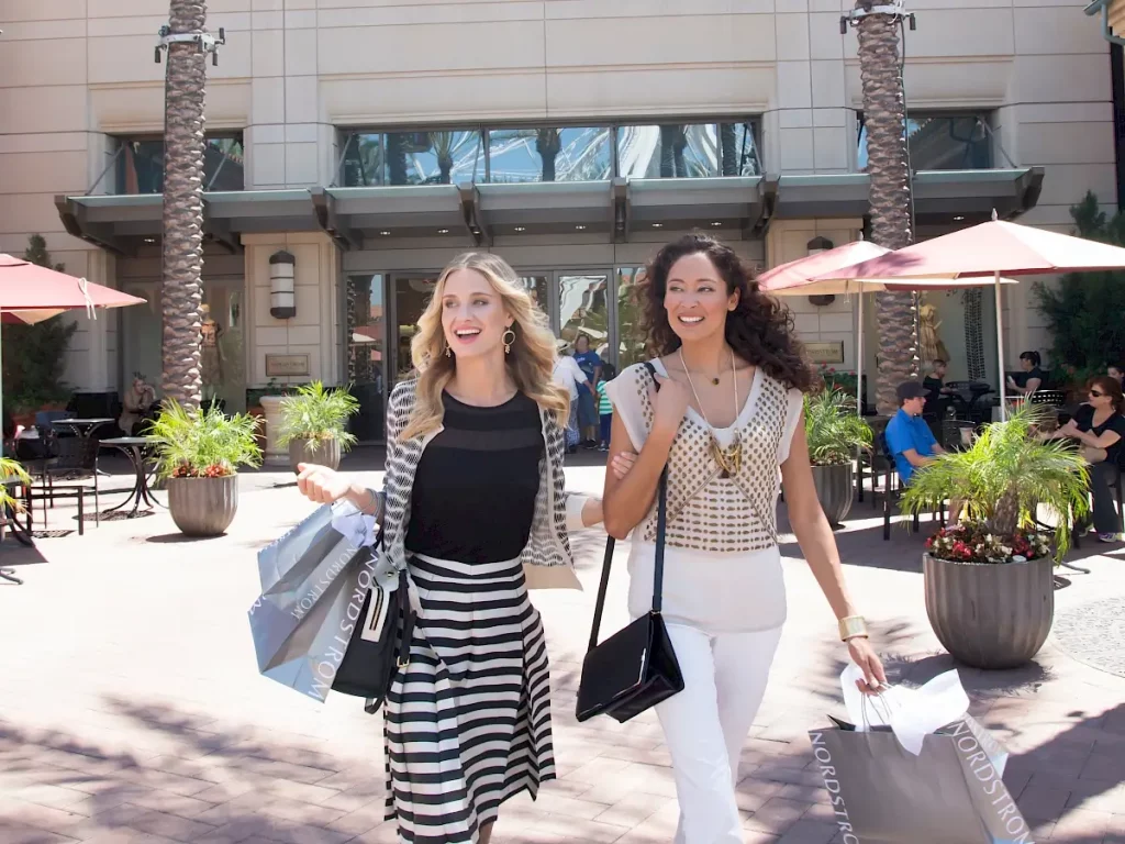 Two women shopping while discussing what to do in irvine