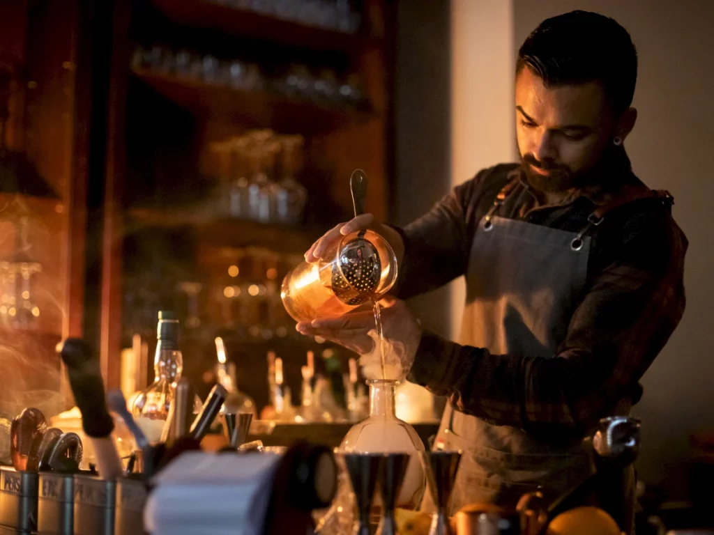 bartender pouring a drink at ynk bar at irvine marriott hotel