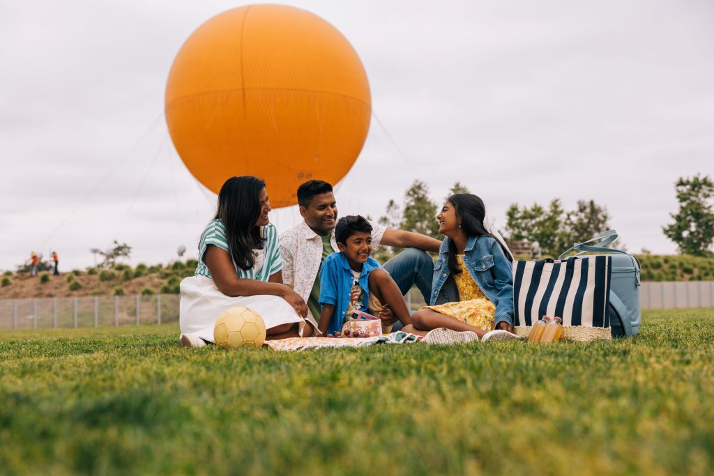 a family sits down for a picnic in irvine california