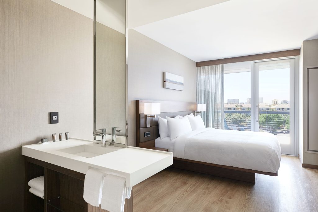 hotel room with balcony and faucet