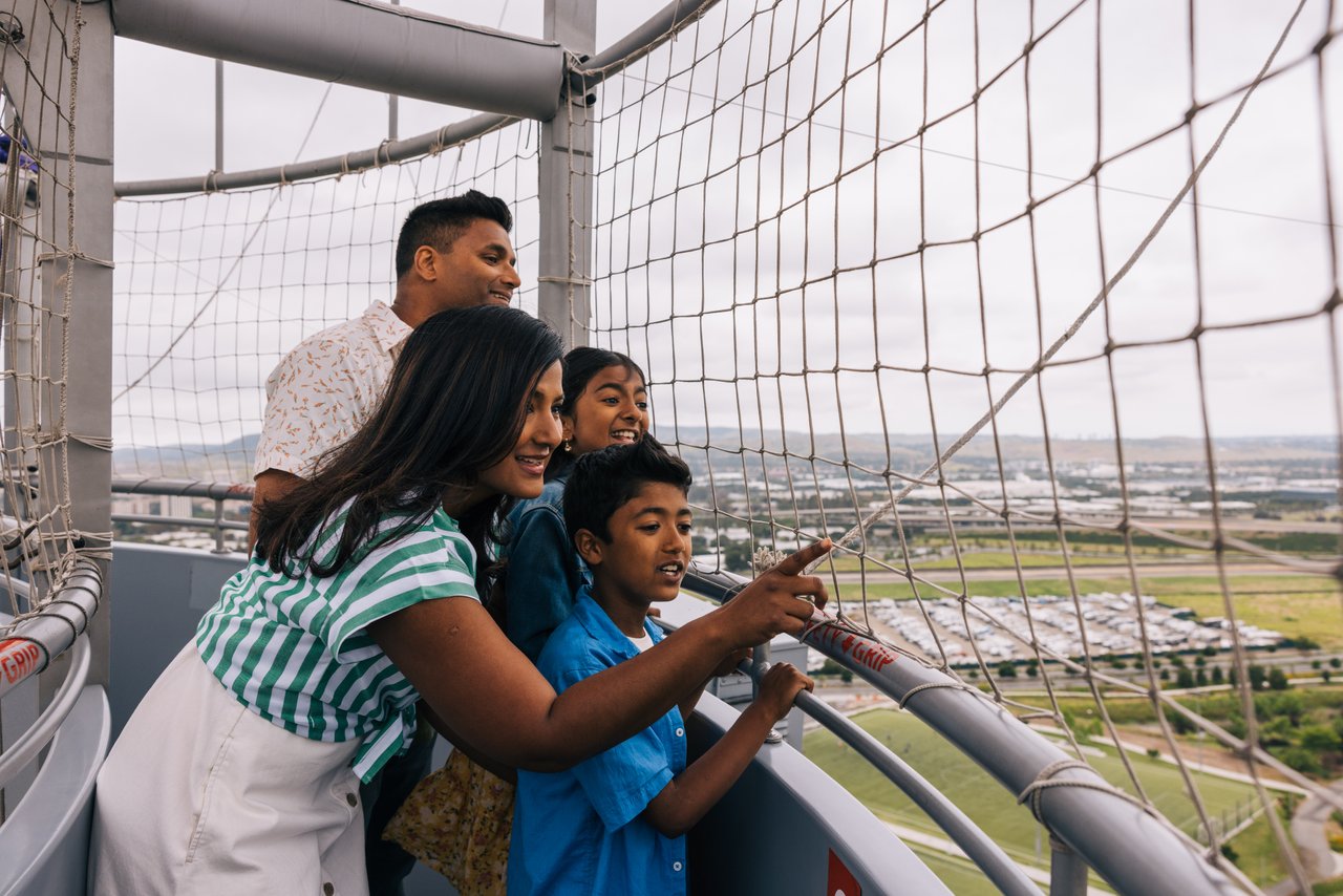 family inside great park balloon ride up in the air looking outside