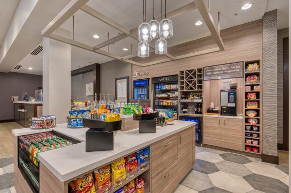 the market convenience store at hilton garden inn hotel filled with chips, drinks, ramen bowls, and a coffee maker