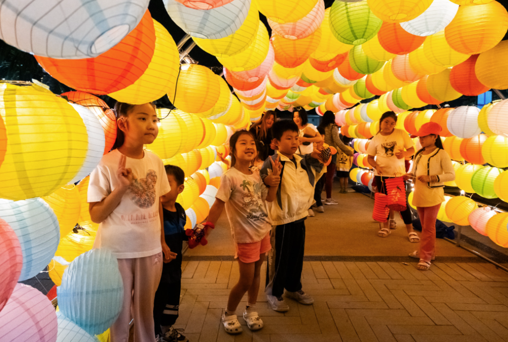 group of children under lanterns during mid autumn festival