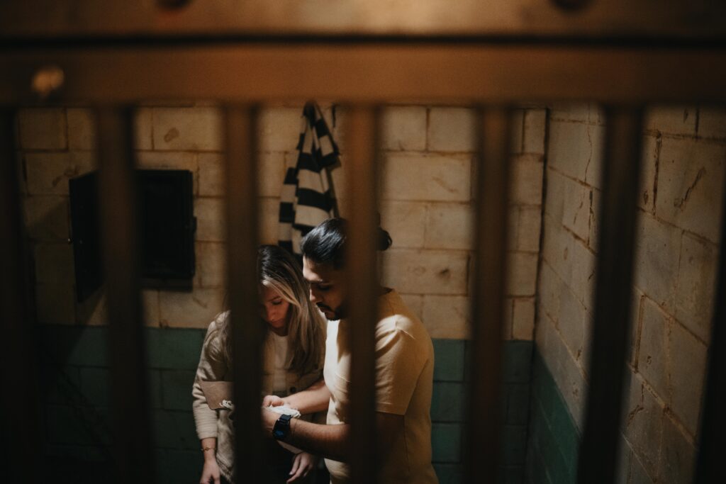 two players inside a caged room called prison break at the escape game