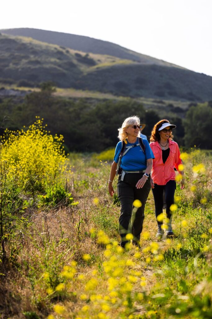 two women walking the trails on a sunny day at bommer canyon irvine