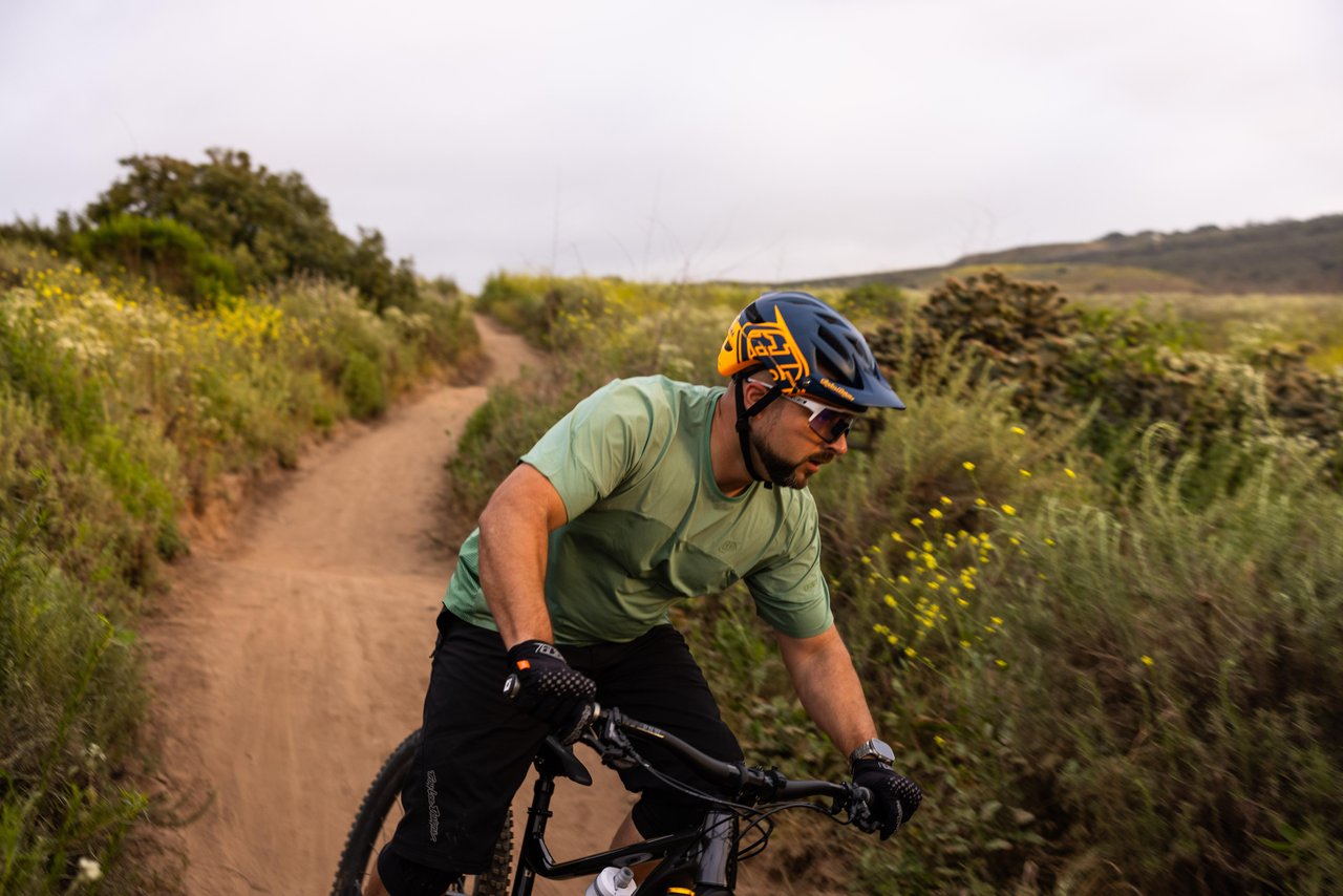 man in helmet riding a bike on a bike trail