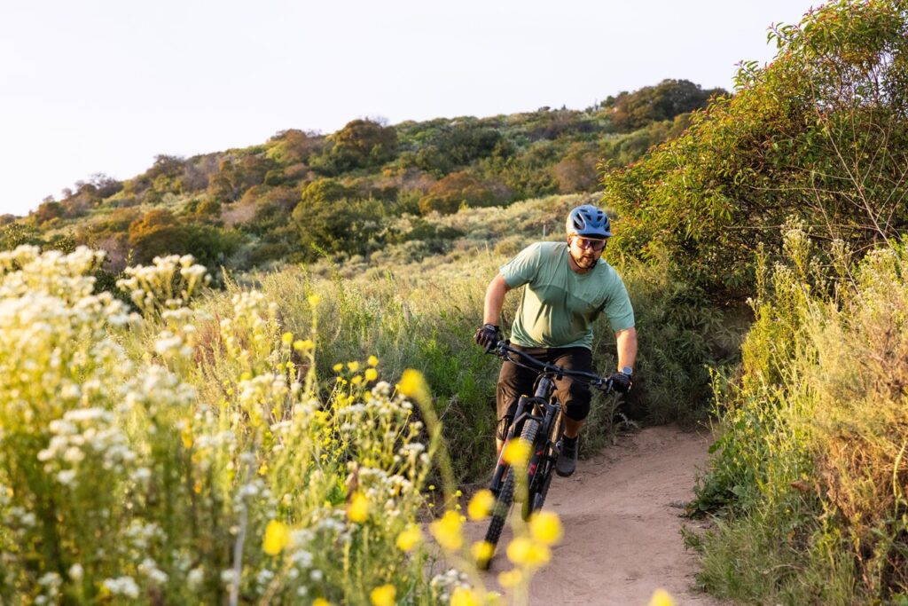 man in helmet riding a bike on a bike trail