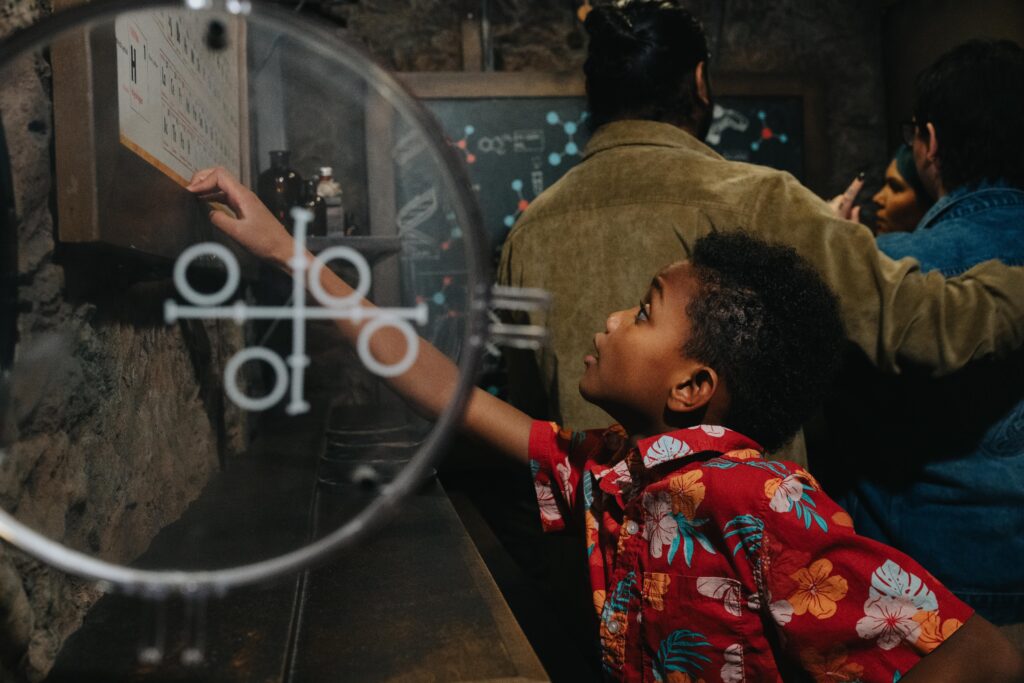 child player at the depths escape room with hands reaching out