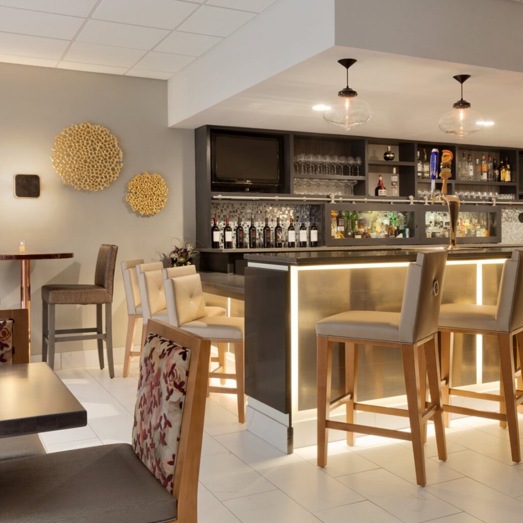 bar area with barstools and wine glasses on shelves at embassy suites irvine