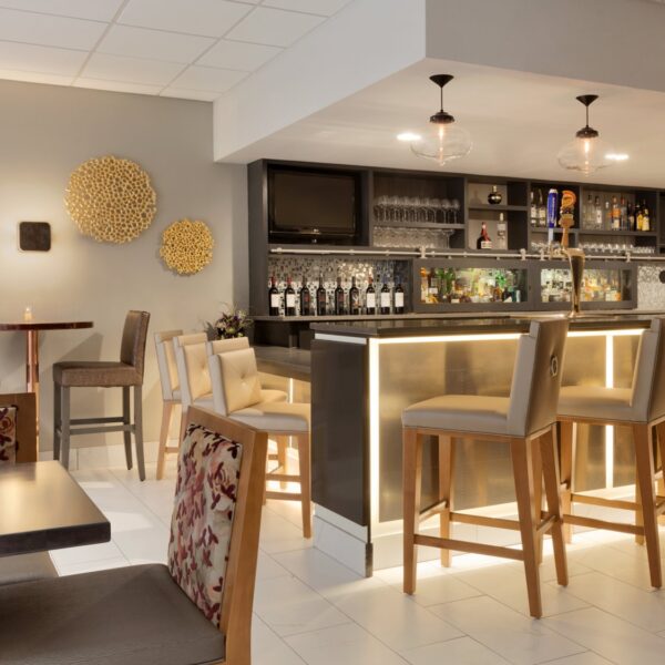 bar area with barstools and wine glasses on shelves at embassy suites irvine