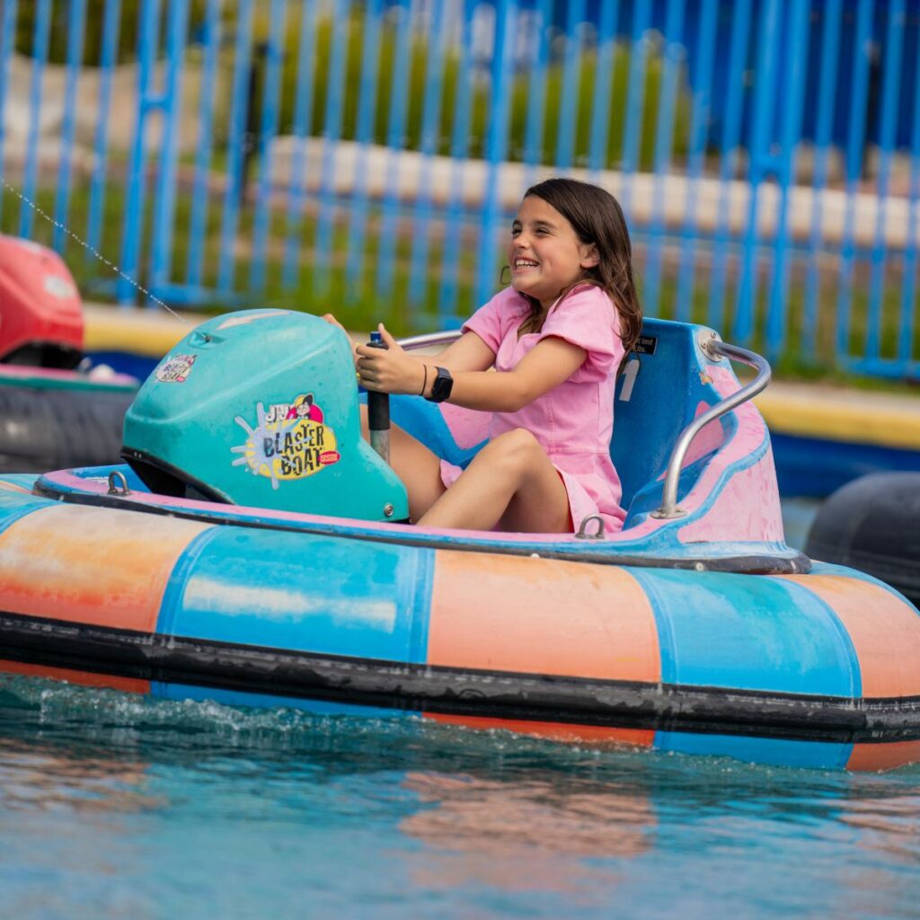 Boomers Irvine 1 girl with brown hair and pink shirt in a water raft