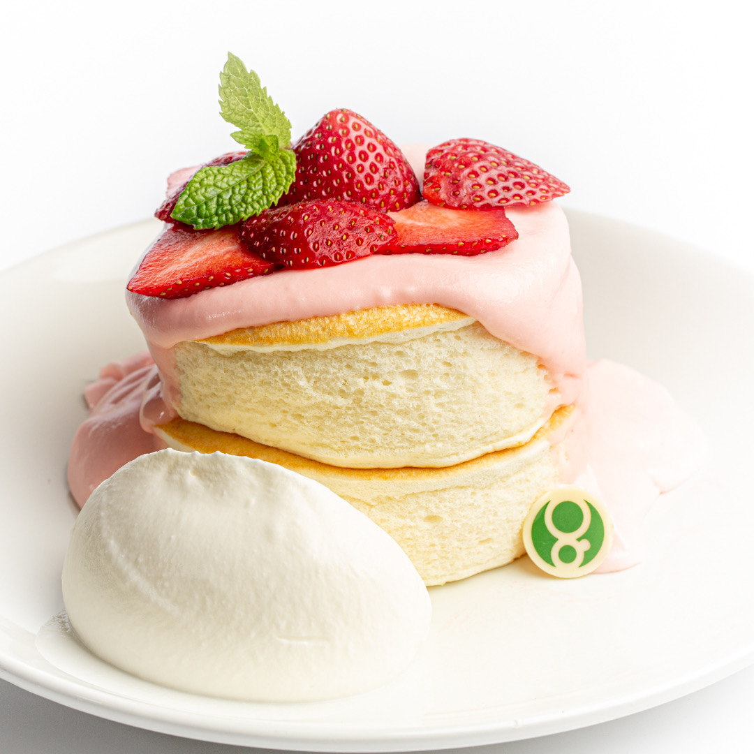 Gram Japanese souffle pancake with strawberry syrup and strawberries on top