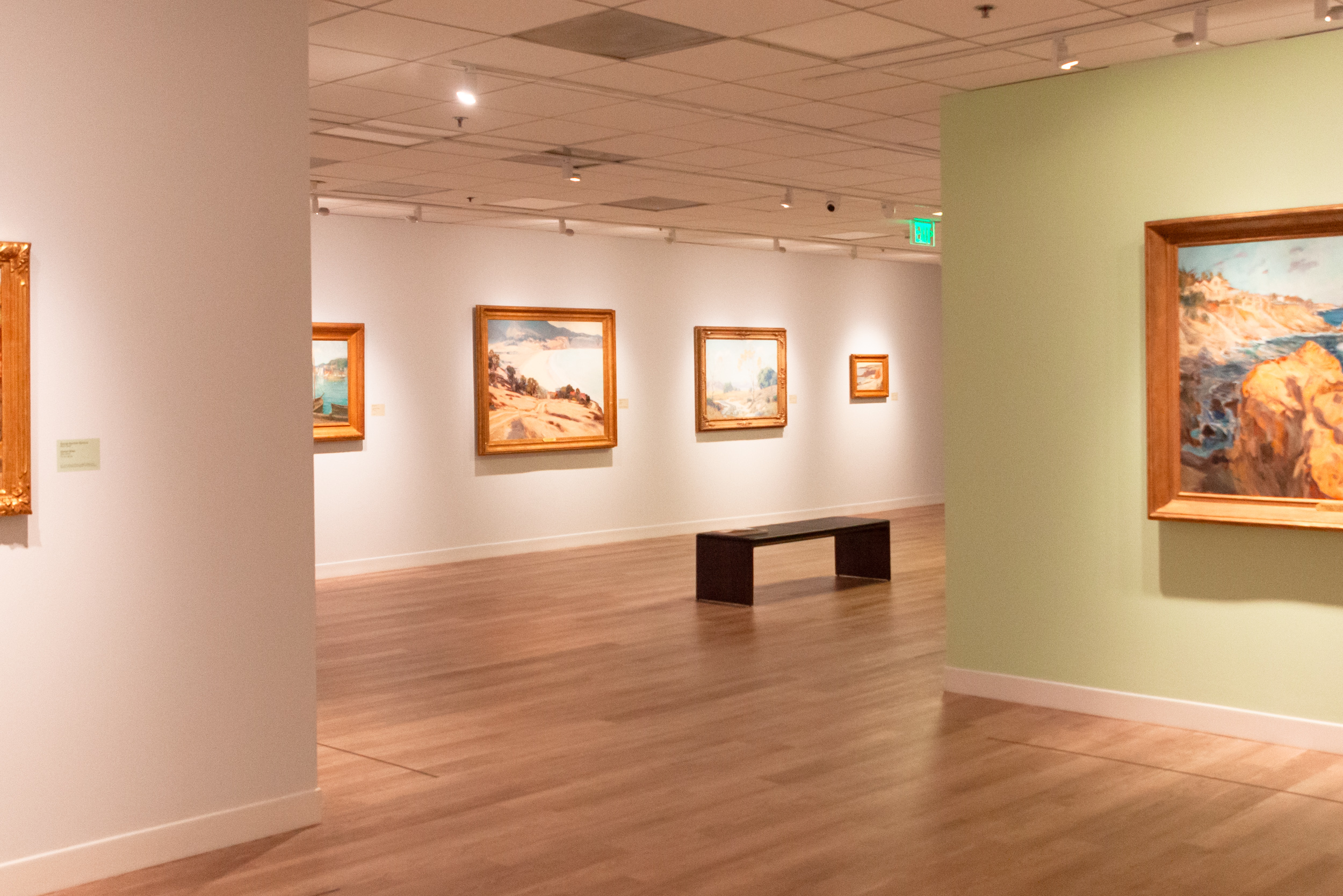 gallery showing California paintings with one bench
