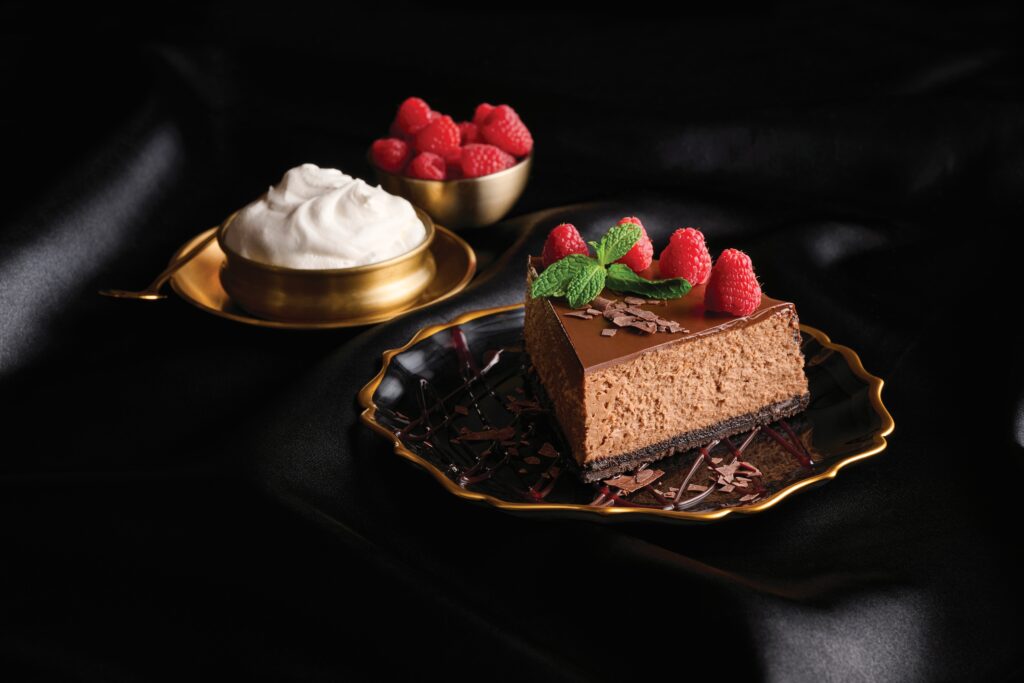 이벤트성 1 photo of chocolate cheesecake with whipped cream and berries