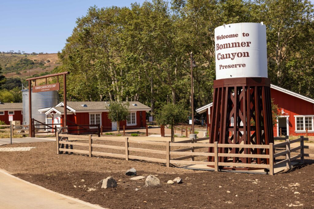water reservoir and red building with picket fences