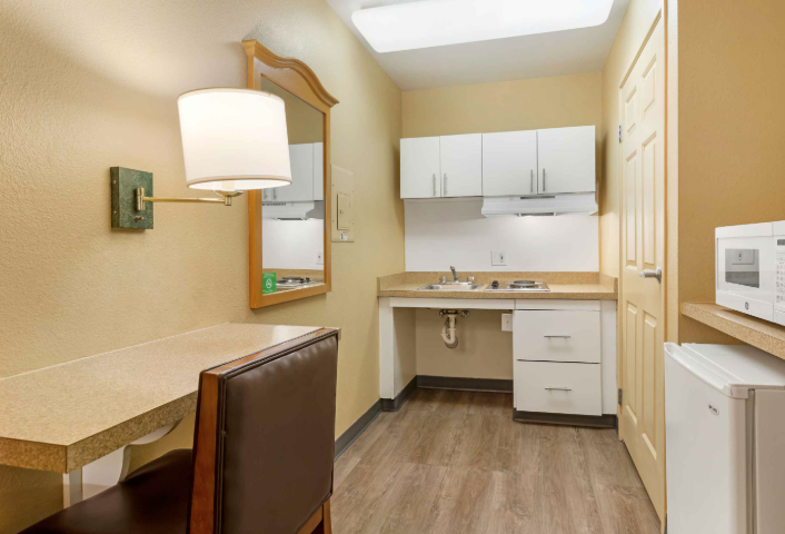 room with built in desk and chair and cabinets