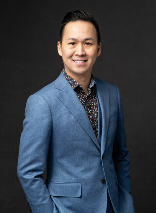 man in blue suit smiling