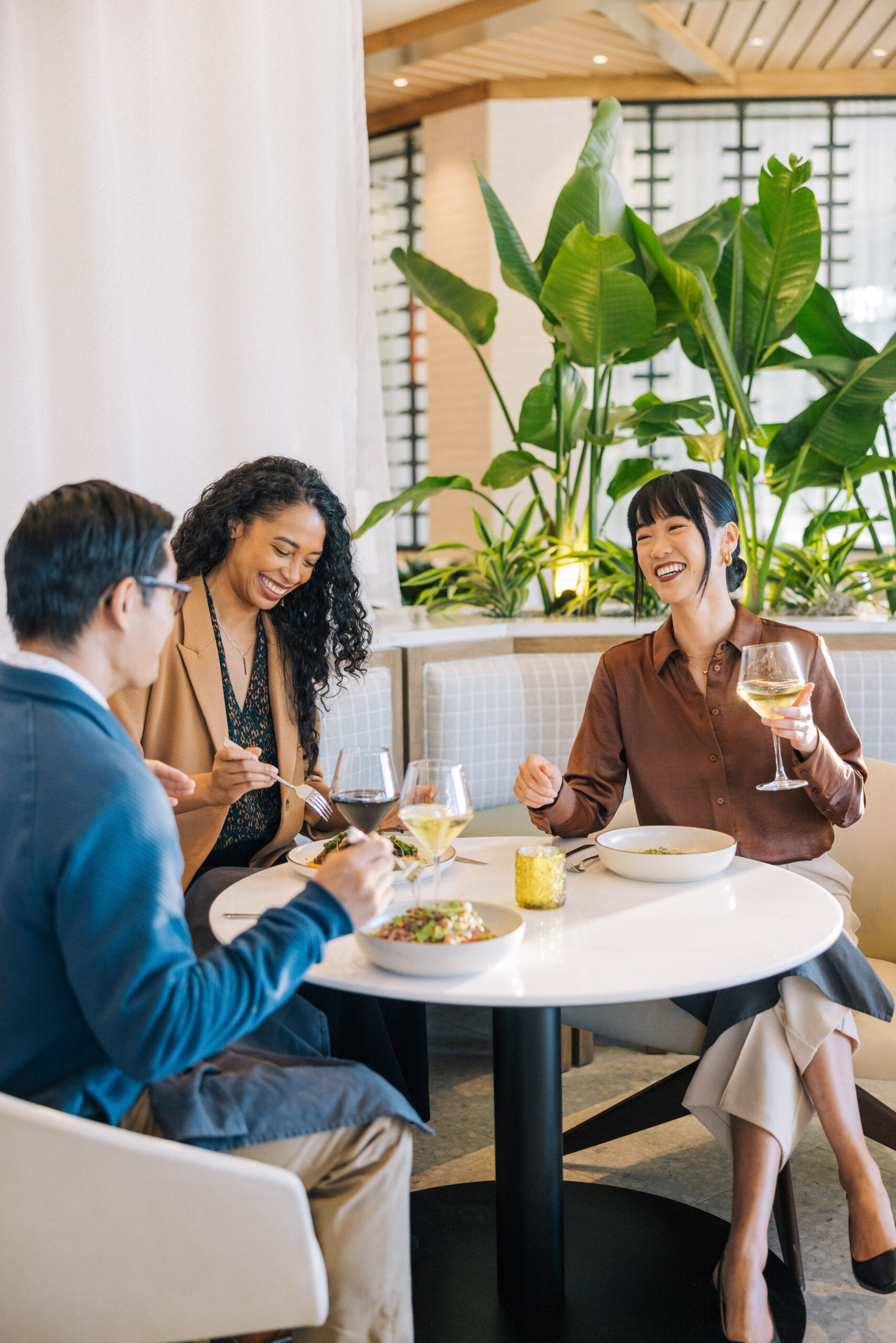 two females and a male having lunch in a restaurant