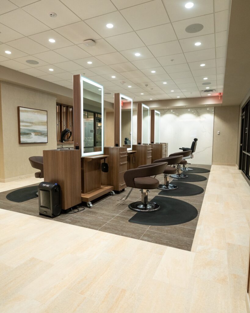 salon with 4 lighted mirrors and 4 swivel chairs