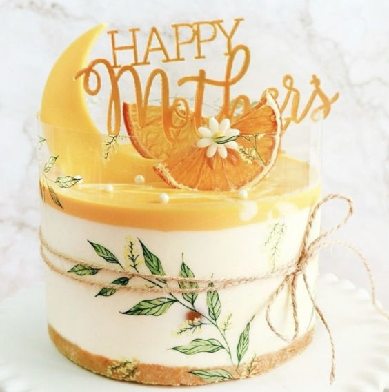 round cake with Happy Mother's Day decor, with moon, orange and leaves as design