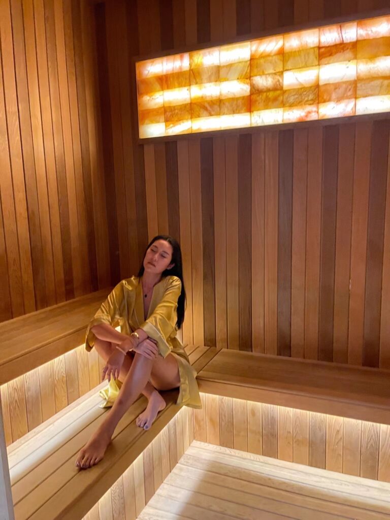 woman in a robe inside a sauna