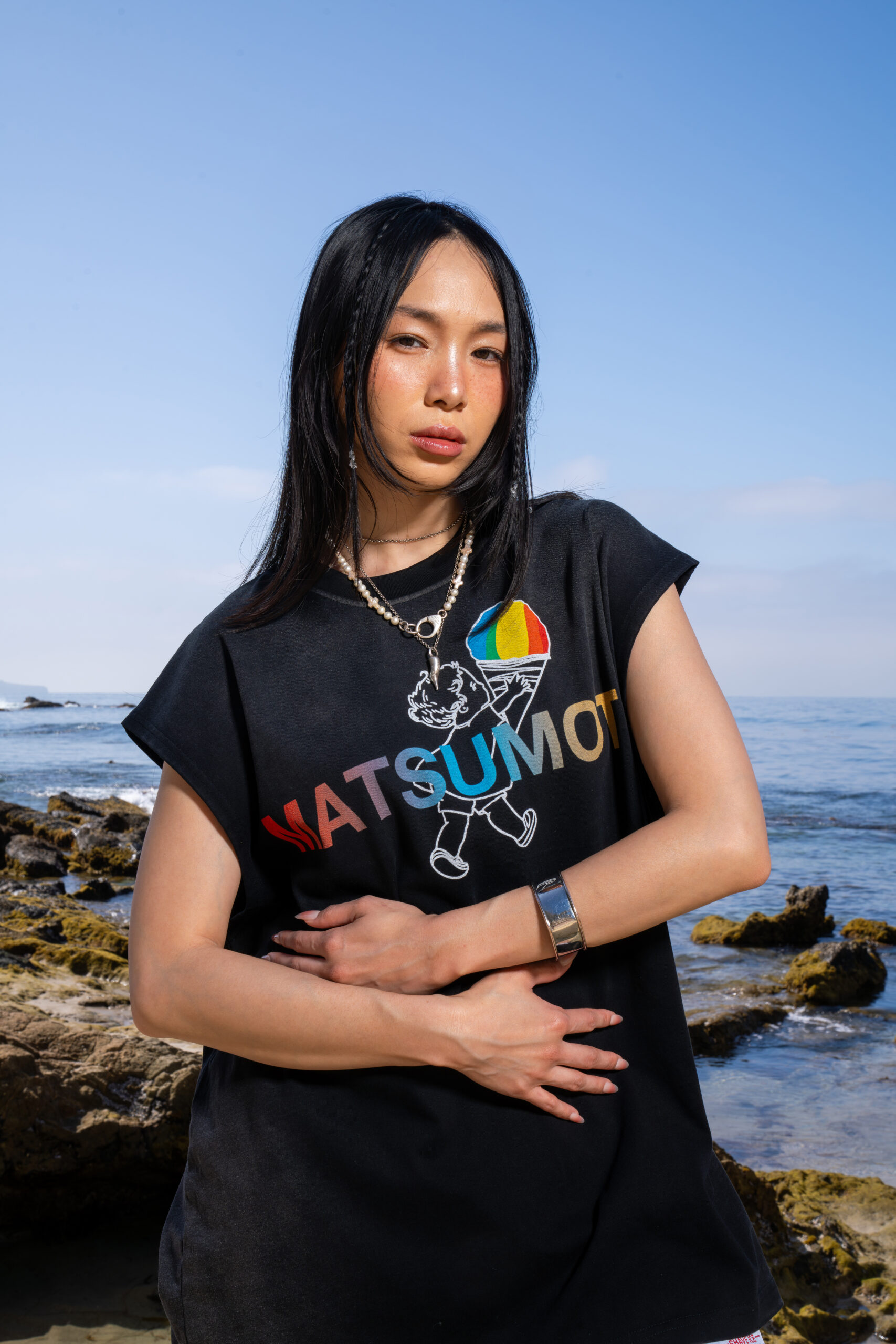 Asian girl in black Matsumoto shirt with arms over her belly