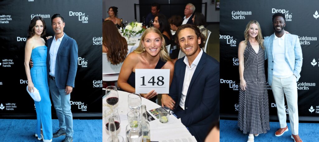 man and woman in formal attire sitting at a round table holding a sign with numbers 148