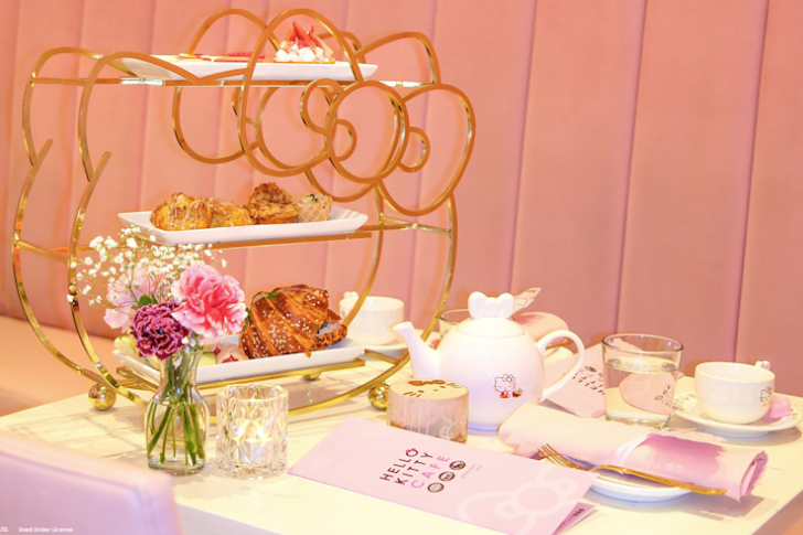 afternoon tea tray at hello kitty cafe with a case of flowers, teapot on the table