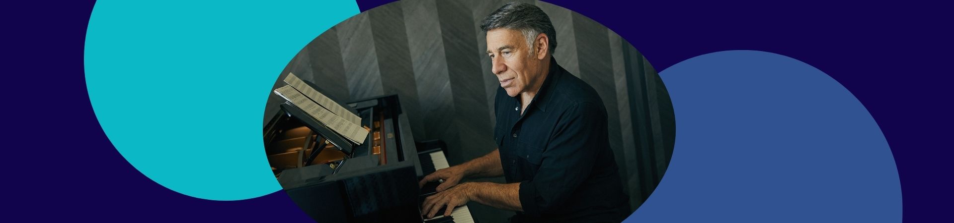 elderly man in black polo shirt playing the piano