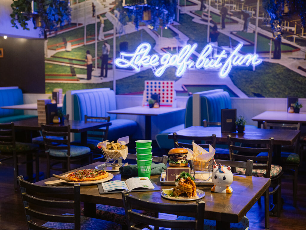 restaurant with neon lights of Like Golf but Fun with food on the table
