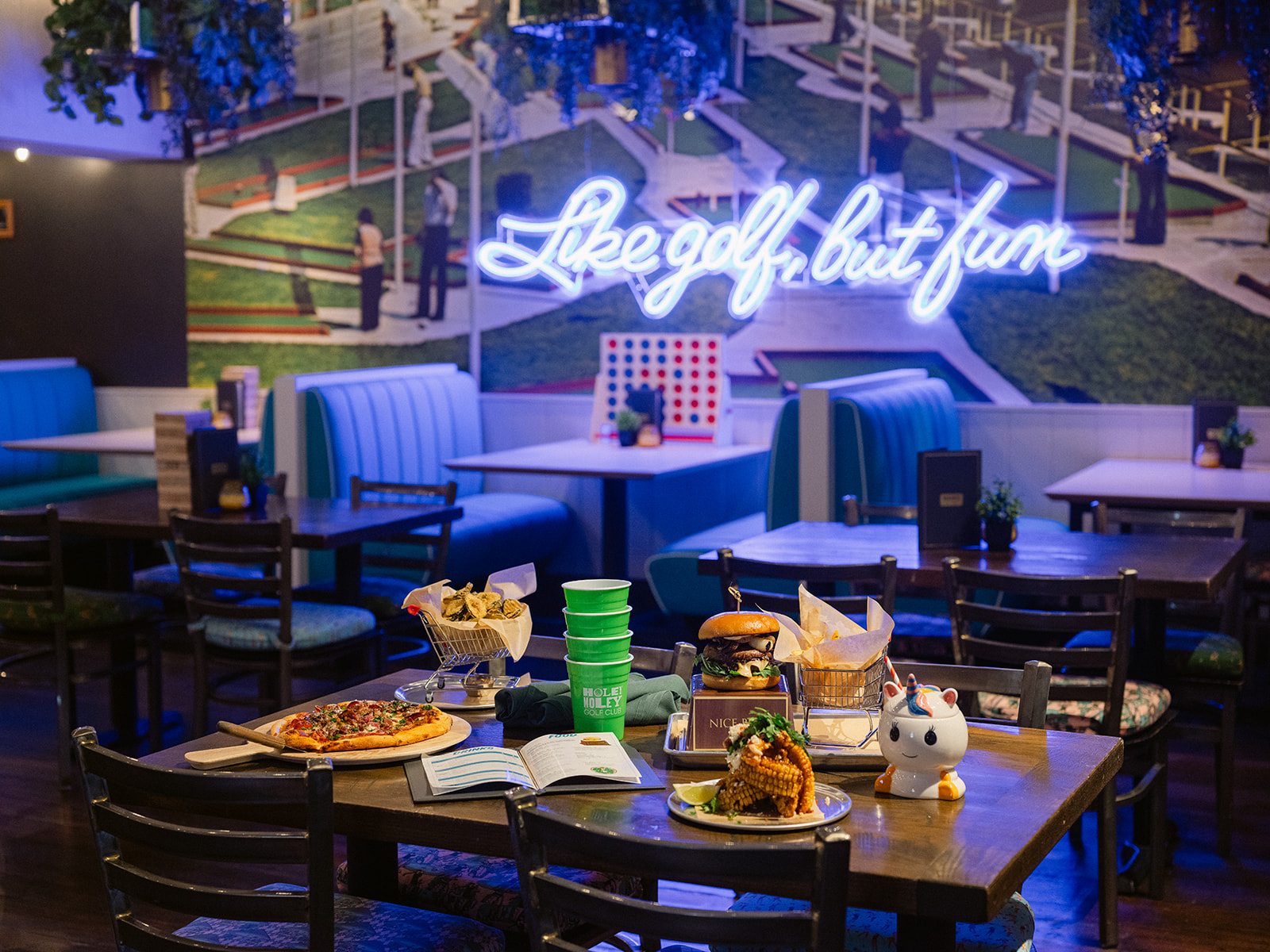 restaurant with neon lights of Like Golf but Fun with food on the table