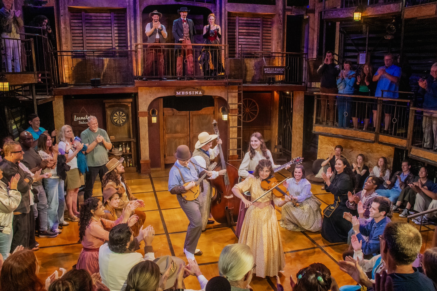 an enclosed theater with actors performing onstage