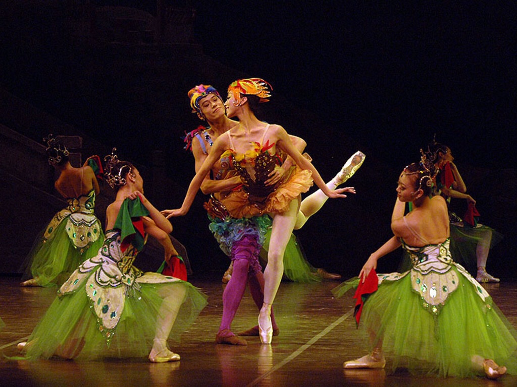 dancers in colorful costumes performing onstage