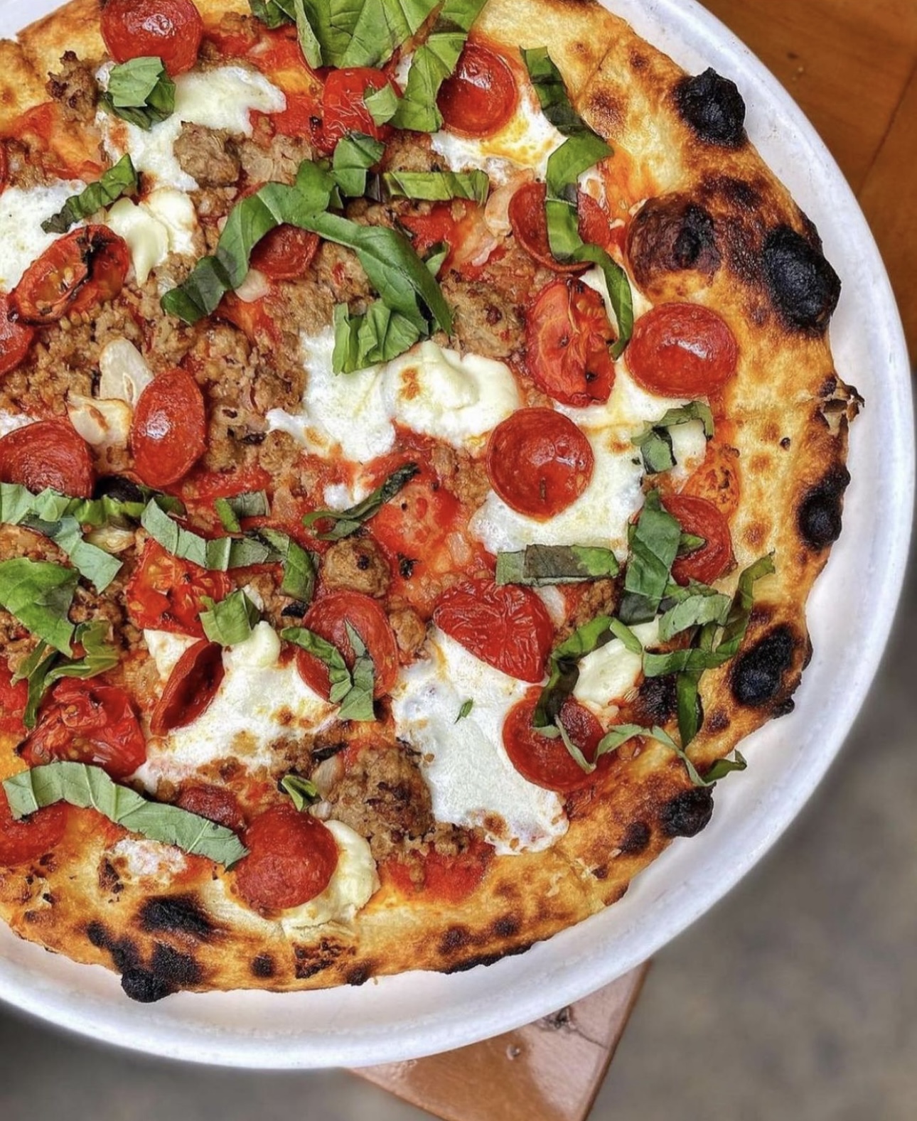 pizza with tomatoes, garnish and cheese