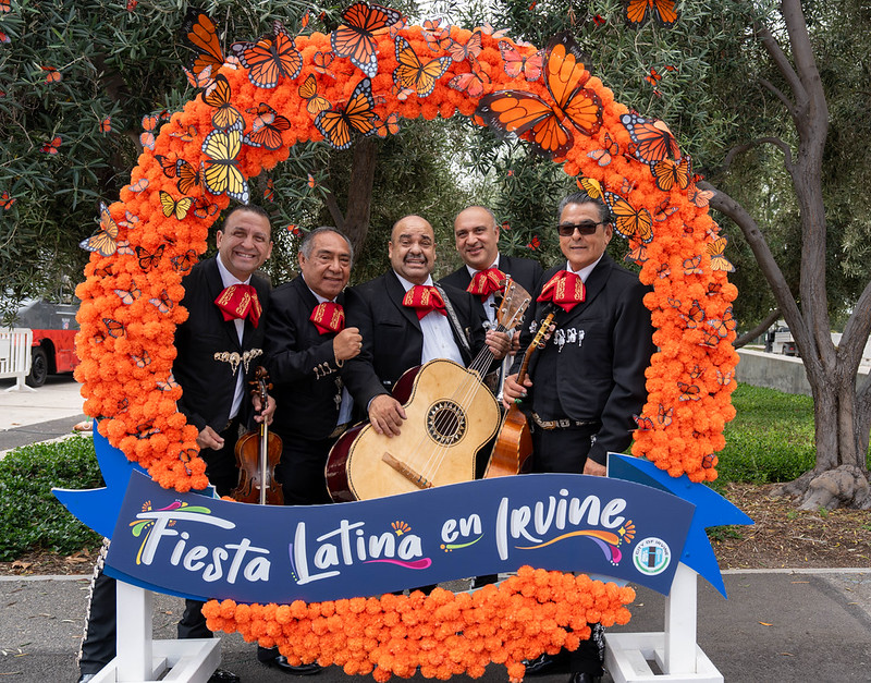 five musicians inside a round orange life size photo frame