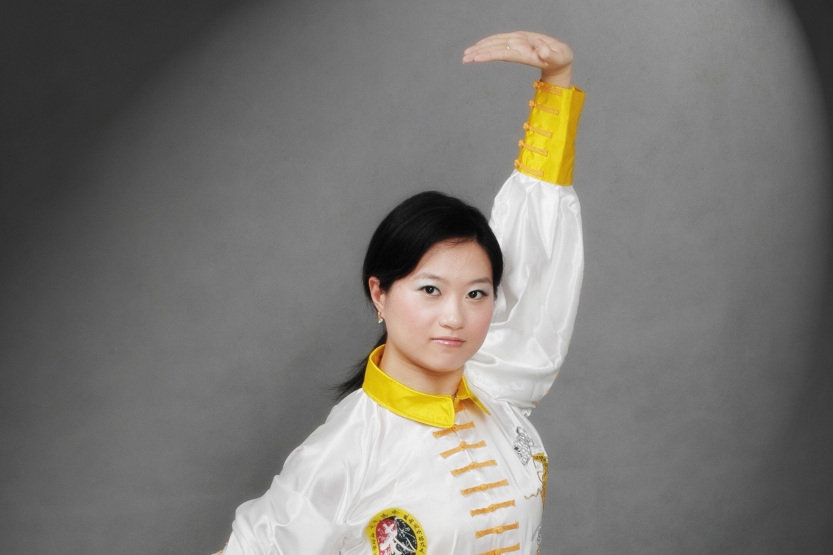 Asian woman in ba duan jin pose