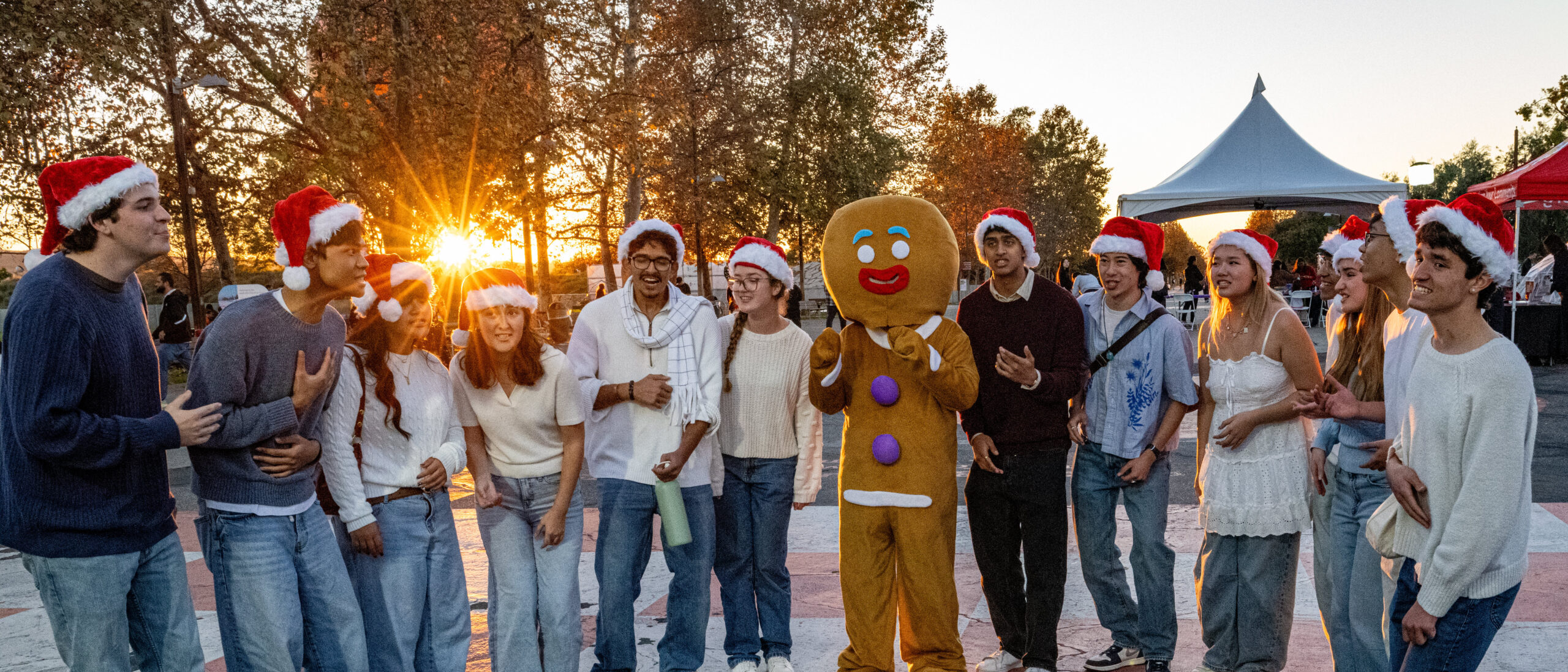 Gingerbread man with teenage carolers