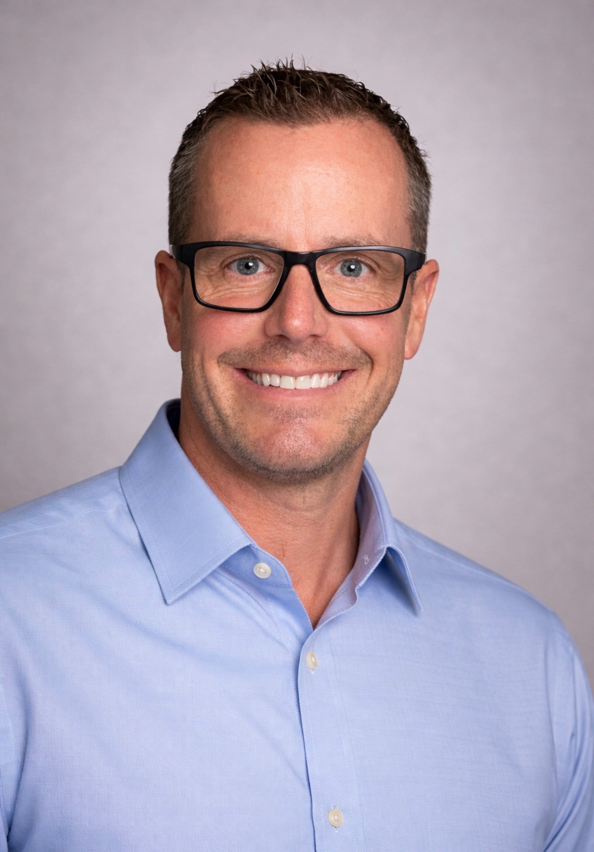 man in eyeglasses and blue polo shirt