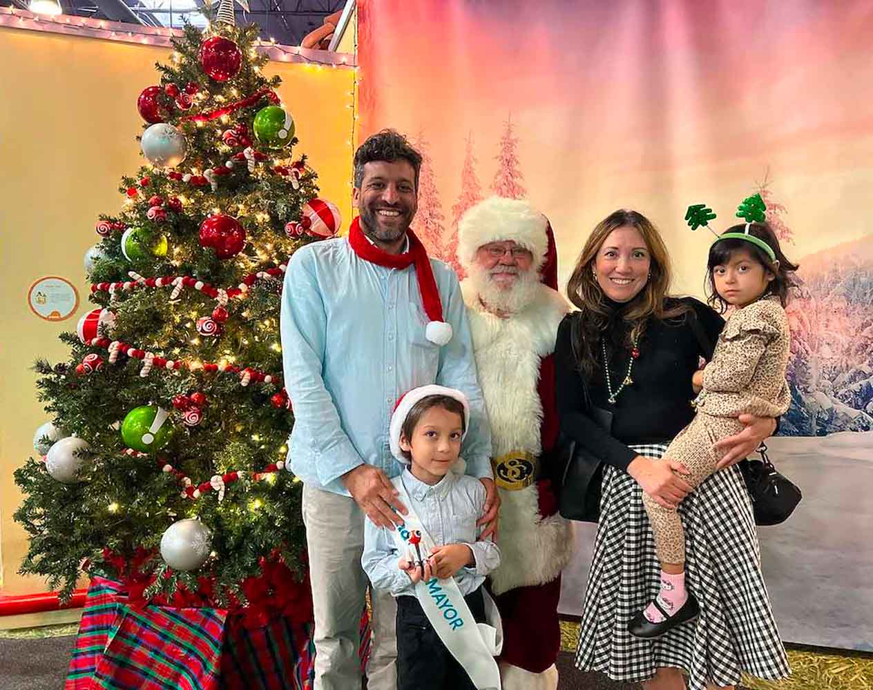 family posing with santa for holidays